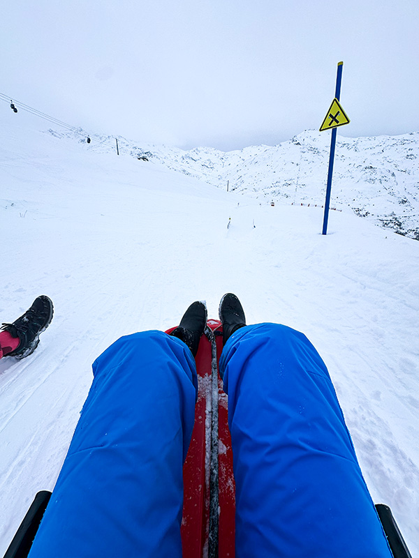 Tobogganing down the slopes Les Menuires winter tip