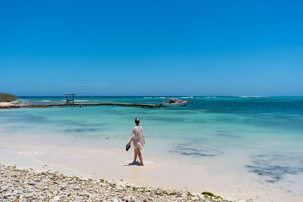 Walking through the surf at Rodger's Beach in Aruba, one of Aruba's most beautiful beaches