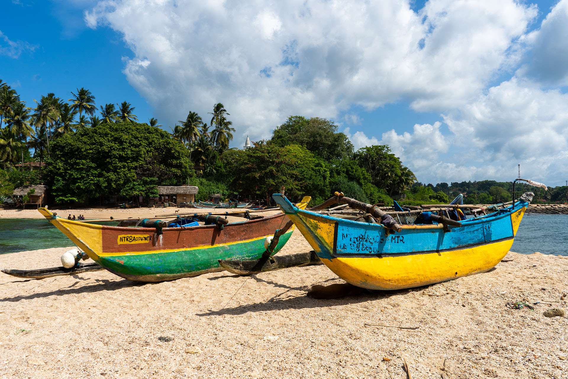 Fishing boats on the beach near Hiriketiya in Sri Lanka, the best travel tips for trips around the world